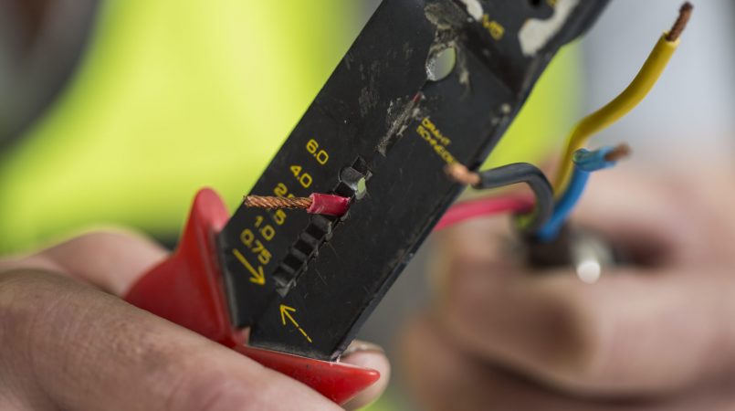 electrician-using-wire-stripper-2022-03-08-01-36-16-utc-scaled.jpg